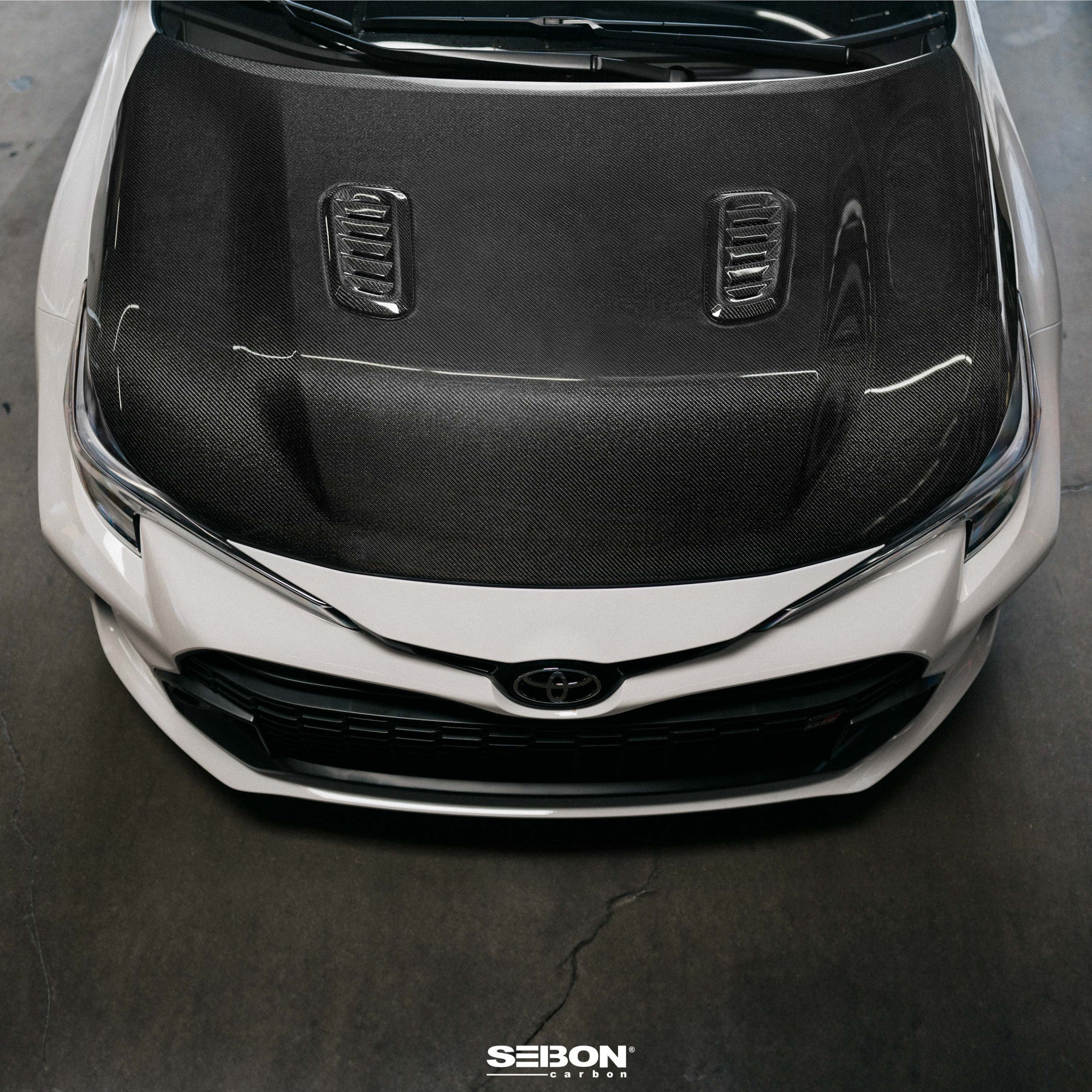 Seibon 2023+ Toyota GR Corolla OE-Style Carbon Fiber Hood - Gloss Finish (HD23TYGRCOR-OE)